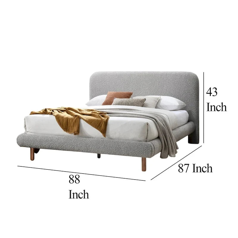 Grand lit avec bords incurvés, revêtement en tissu bouclette gris et pieds en bois marron