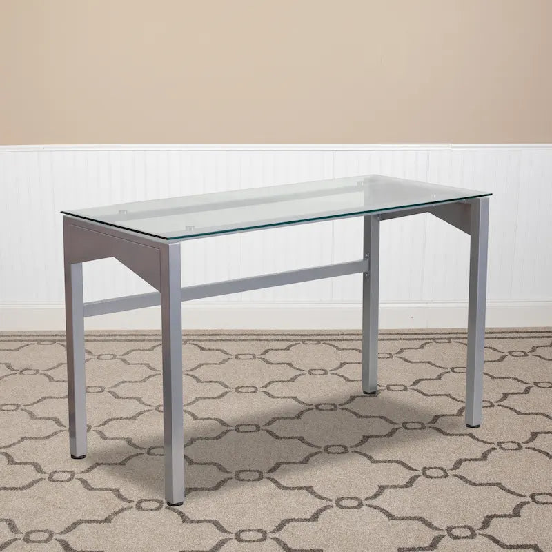 Bureau contemporain en verre trempé transparent avec pieds géométriques et cadre argenté